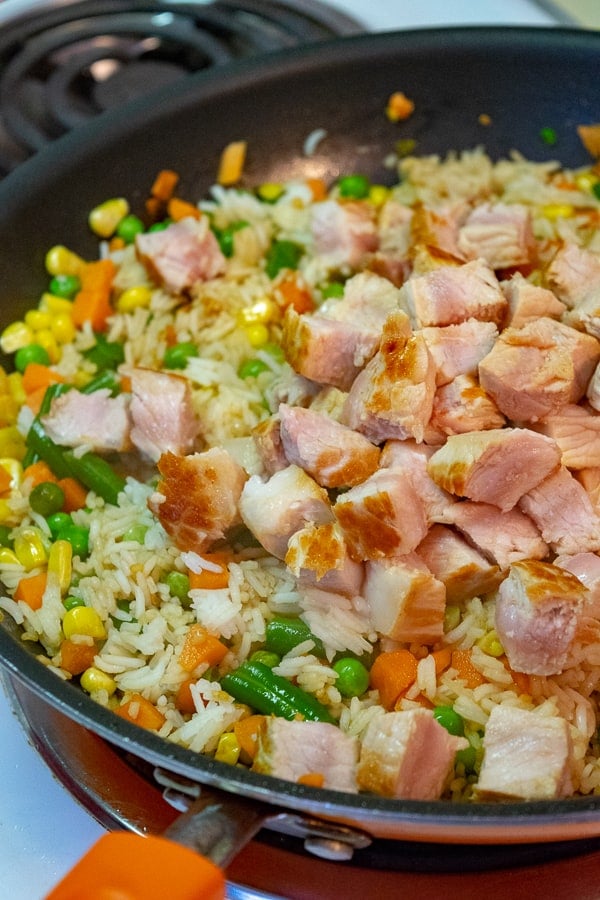 Pork being added to the skillet