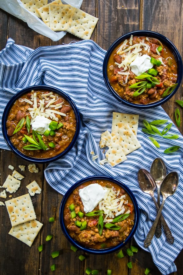 an overhead shot of 3 bowls of Secret Ingredient Turkey Chili on a table