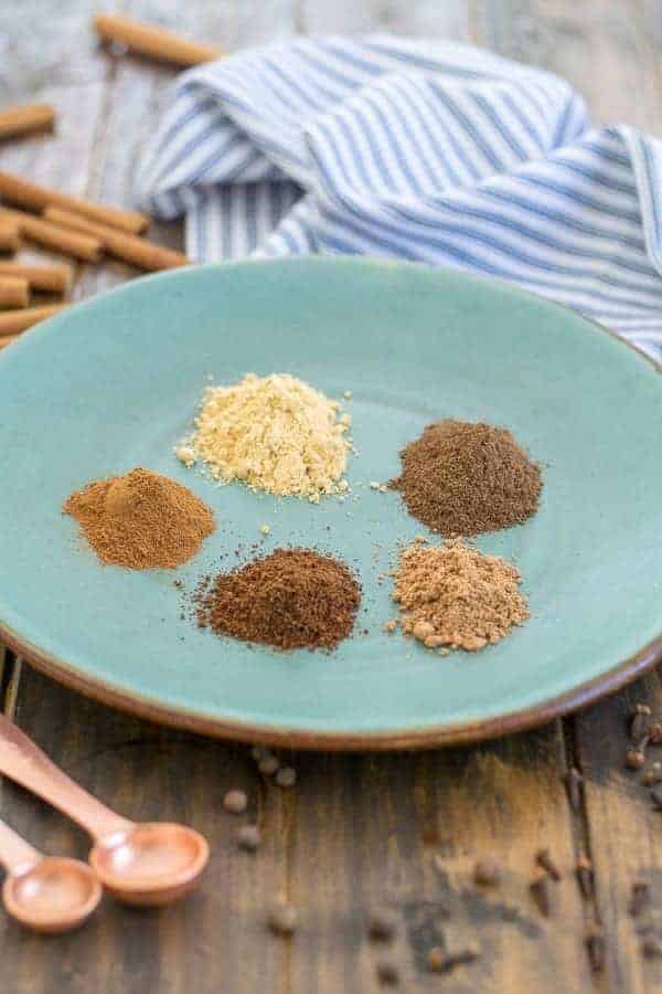 5 spices on a plate to make gingerbread spice