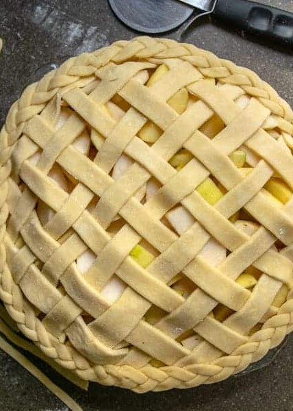 all butter pie crust used to make a lattice top and braided decorated edge on an apple pie