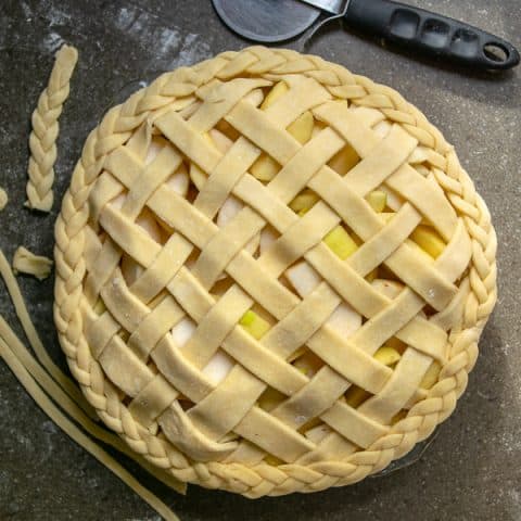 all butter pie crust used to make a lattice top and braided decorated edge on an apple pie
