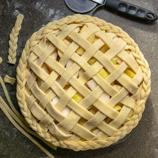 all butter pie crust used to make a lattice top and braided decorated edge on an apple pie