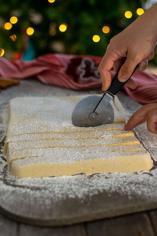 cutting a sheet of gingerbread marshmallows