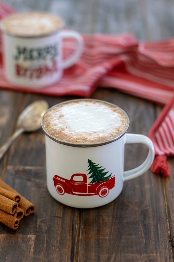 a skinny gingerbread tea latte with foam in a white mug on a table