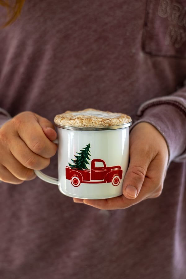 a person holding a skinny gingerbread tea latte