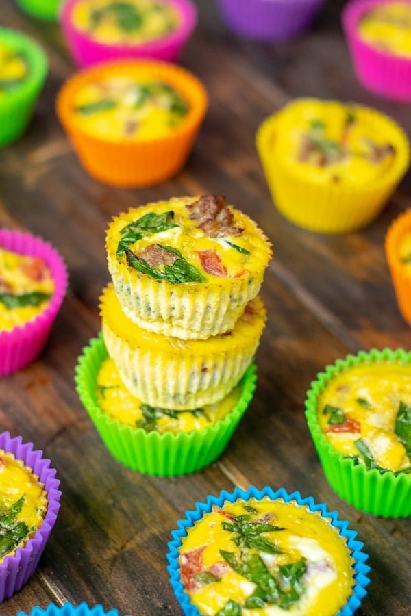 a stack of fresh cooked spinach sausage egg muffins