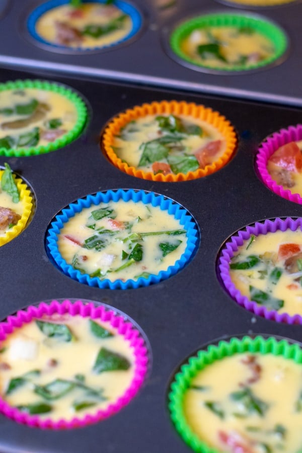 all of the ingredients assembled in the muffin tins ready to cook