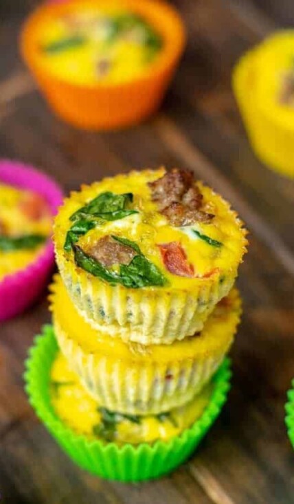 close up of a freshly made spinach, sausage, tomato egg muffin