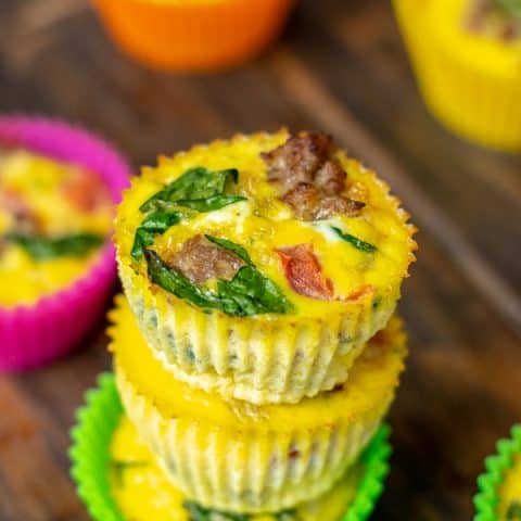 close up of a freshly made spinach, sausage, tomato egg muffin