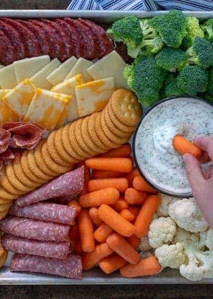 dipping into a dip on a snack platter