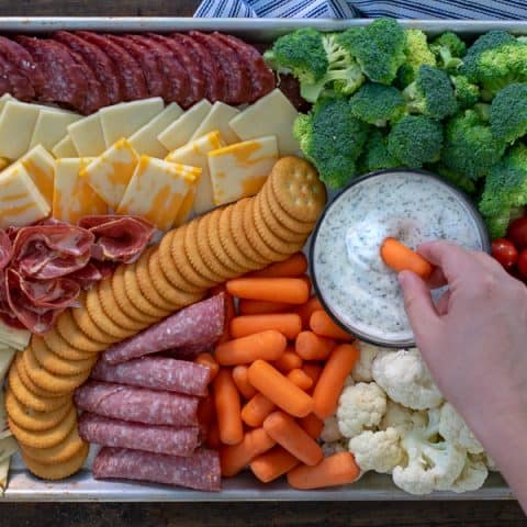 dipping into a dip on a snack platter