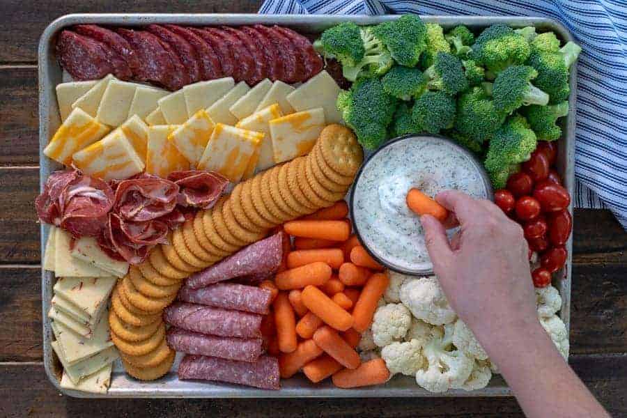 dipping into a dip on a snack platter