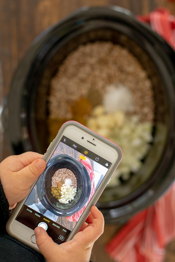 a picture of a toddler taking a picture of the ingredients for crockpot refried beans