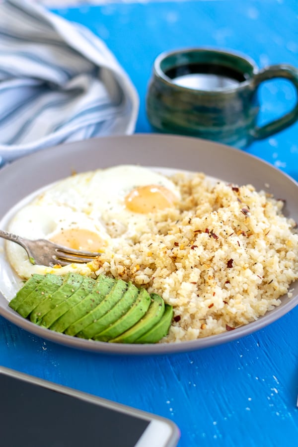 plate with eggs, rice, and avocado