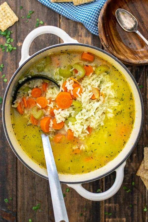 carrots, celery, and rice in a soup pot