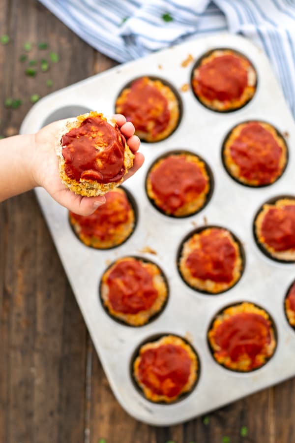 toddler hand holding a turkey meatloaf muffin