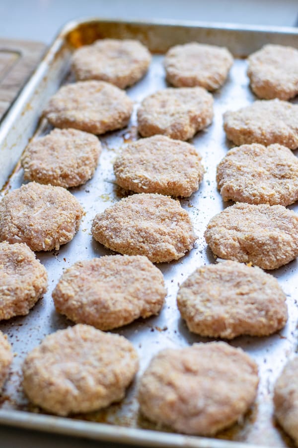 uncooked freshly formed chicken nuggets ready for the oven