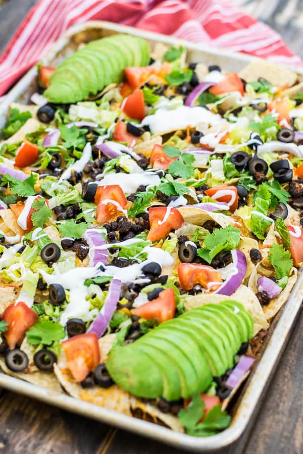 tray of seasoned black bean nachos with toppings