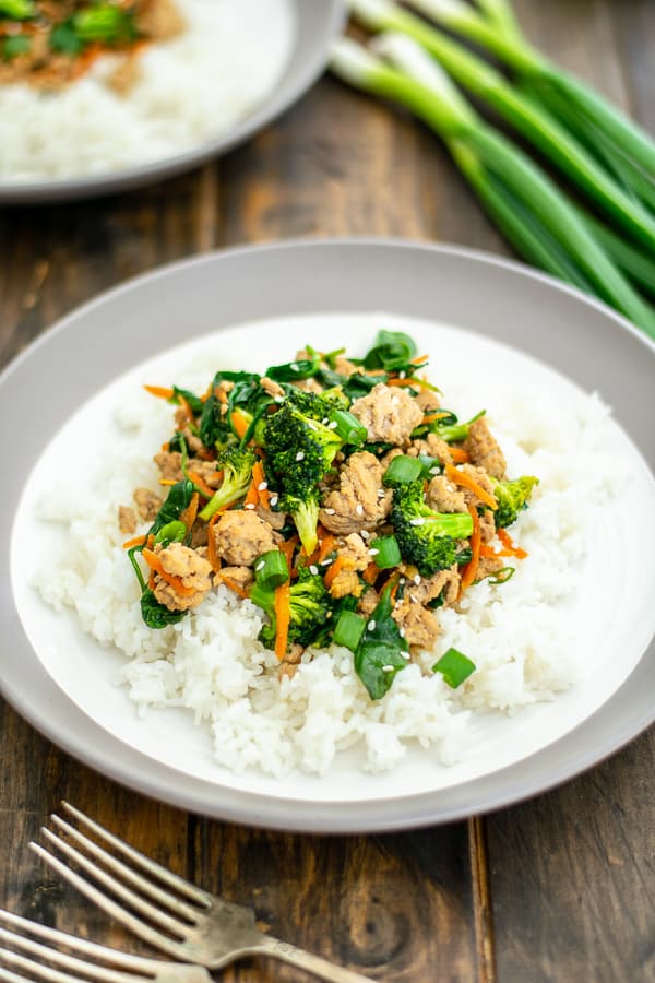 ground pork stir fry on a pile of rice on a white plate
