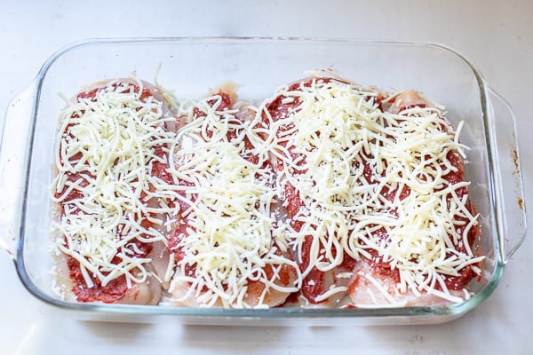 step 2 of topping the chicken, adding the cheese