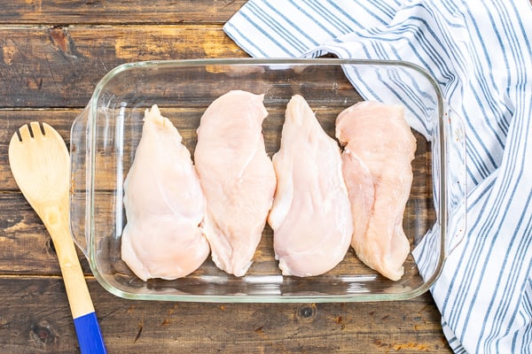 chicken breasts lined in a casserole dish for step 2 of the recipe