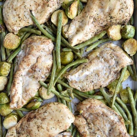 sheet pan with baked chicken, green beans, and brussel sprouts