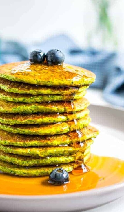 close picture of a stack of green oatmeal packs with syrup drizzling down the side