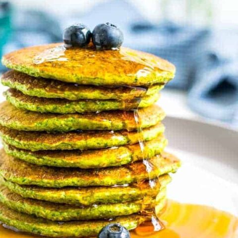 close picture of a stack of green oatmeal packs with syrup drizzling down the side