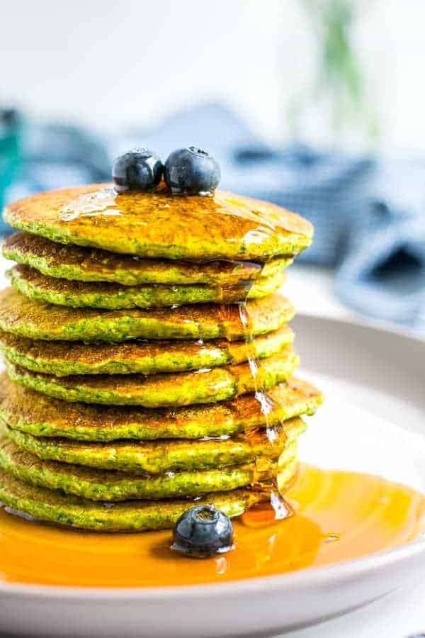 close picture of a stack of green oatmeal packs with syrup drizzling down the side