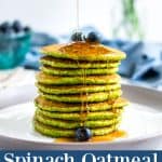 Spinach pancakes in a stack with a drizzle of maple syrup running down the front
