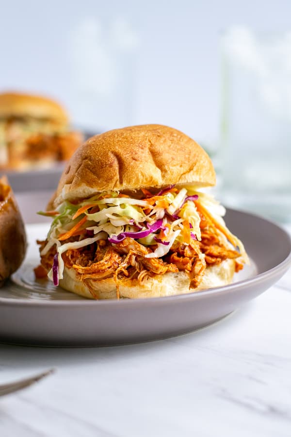 Healthy BBQ Pulled Chicken On a sandwich with coleslaw on a bun
