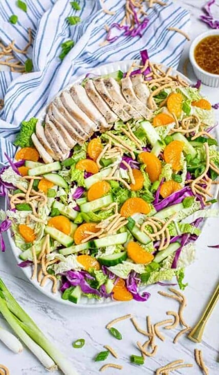 Asian Chopped Chicken Salad on a large plate on a tables with garnishes