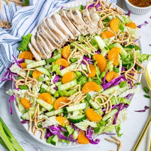 Asian Chopped Chicken Salad on a large plate on a tables with garnishes