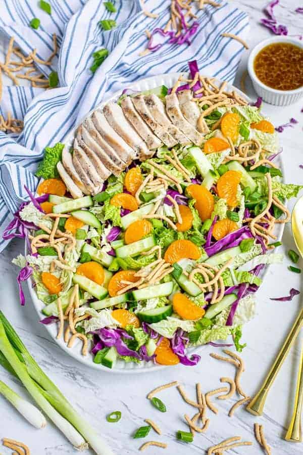 Asian Chopped Chicken Salad on a large plate on a tables with garnishes