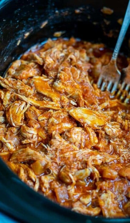 close up of pulled bbq chicken in the slow cooker