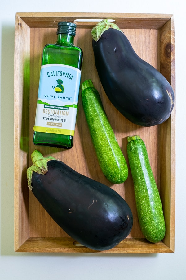 olive oil, zucchini, eggplant on a wooden tray