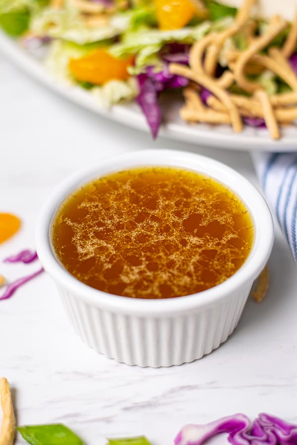 small white bowl filled with homemade sesame vinaigrette dressing