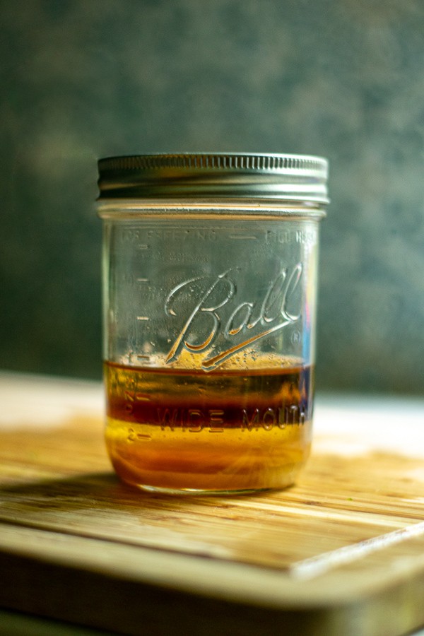 ball jar with all of the ingredients needed for making the sesame vinaigrette