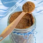 spoon full of taco seasoning blend resting on a jar full of taco seasoning