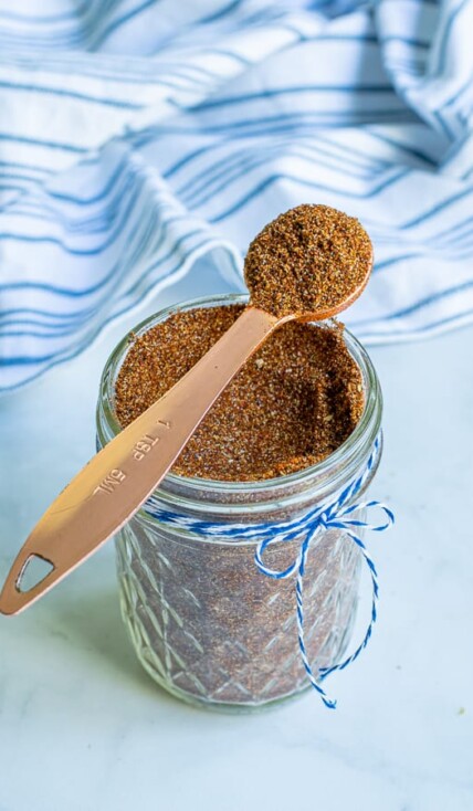 spoon full of taco seasoning simple resting on a jar full of taco seasoning