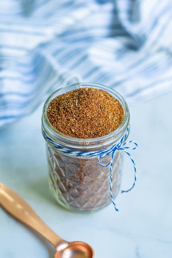 jar with a little blue bow full of freshly mixed simple taco seasoning