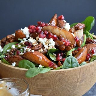 large wood bowl holding the roasted pear salad
