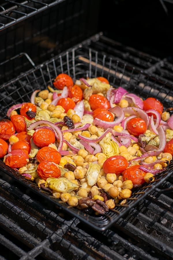 chickpea salad in a grilling basket on the grill