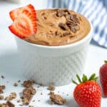 chocolate hummus with chocolate shavings and sliced strawberries
