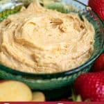 close up of peanut butter dip for fruit in a blue bowl