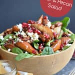 Roasted Pear Salad in a large bowl with pecans, pomegranates, and goat cheese