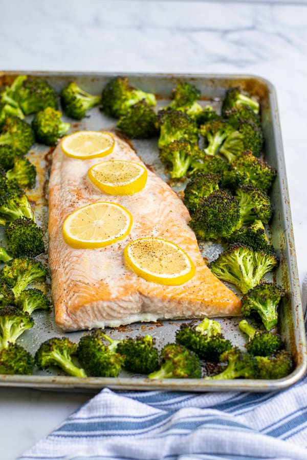 salom and broccoli just baked on a single sheet pan with lemons