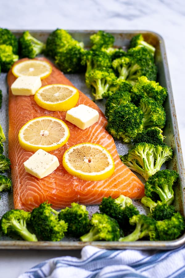 raw salmon on a sheet pan ready to be put in the oven