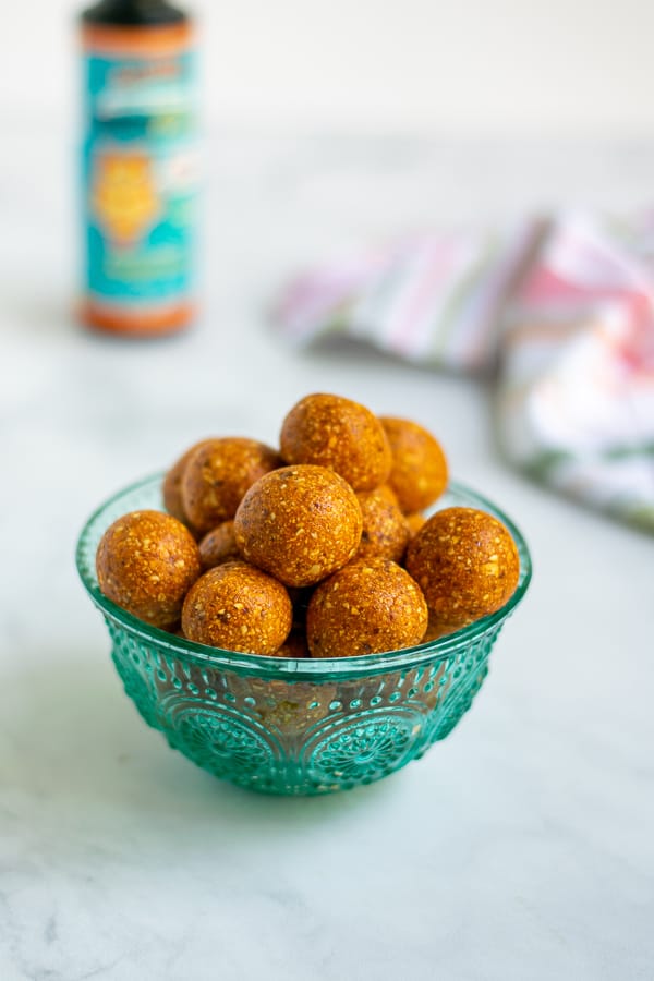 teal bowl overflowing with easy to make tropical energy bite snacks