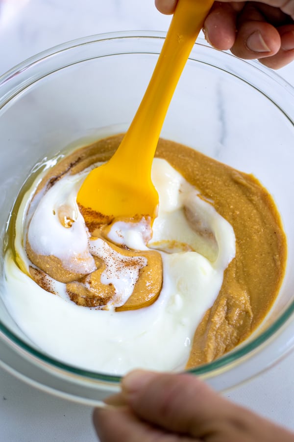 spoon stirring together the ingredients to make peanut butter fruit dip for fruit